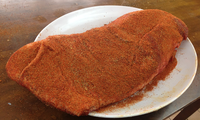 beef brisket with rub ready for the slow-smoker