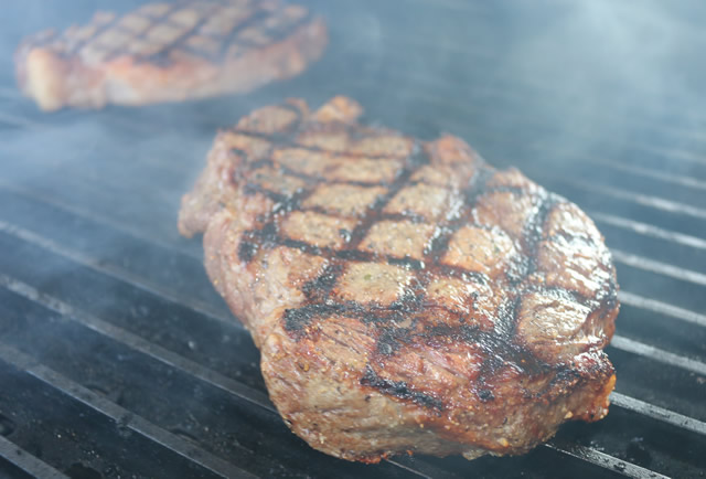 ribeye steak on charcoal grill